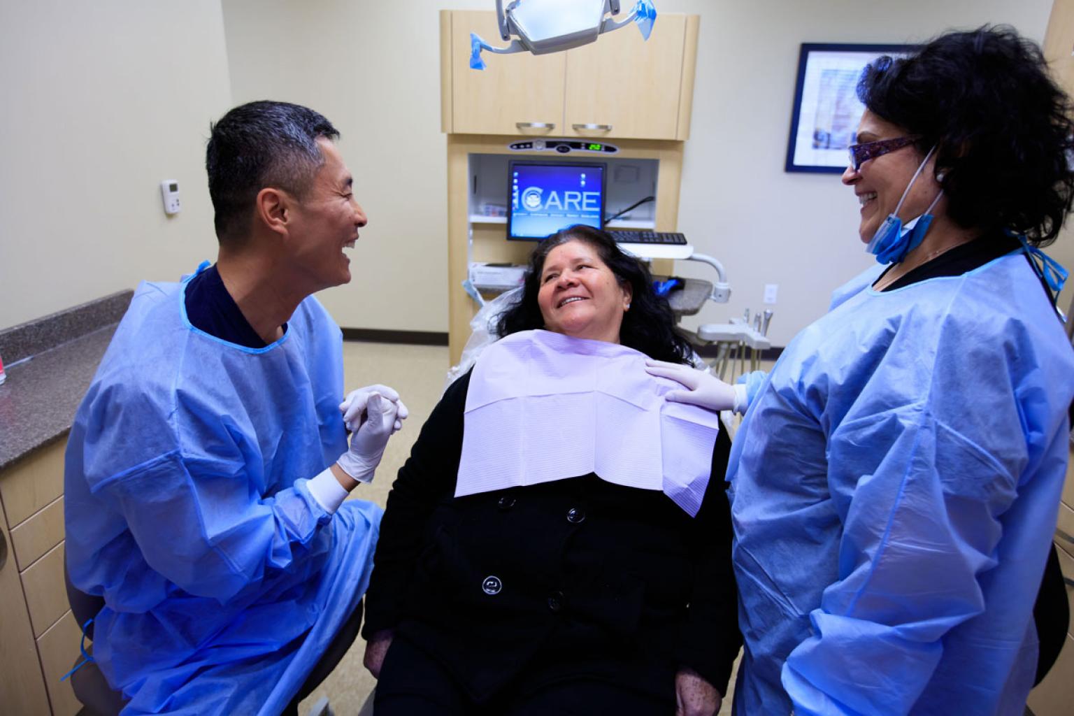 Dentist, Nurse, and Patient Laughing